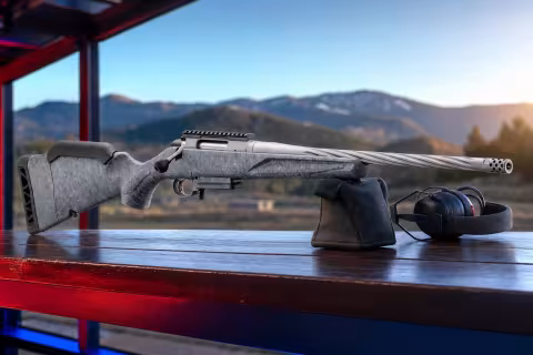 Ruger American Rifle Generation II na streleckej lavici s ochrannými slúchadlami.